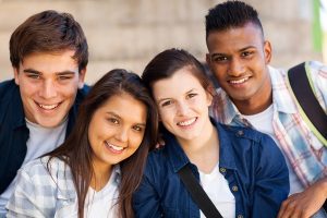 group of happy teen high school students outdoors